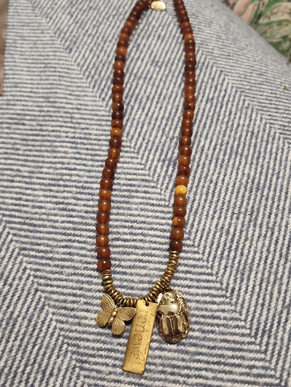 Gold Charm Brown Beaded Necklace with Butterfly and Scarab Charms